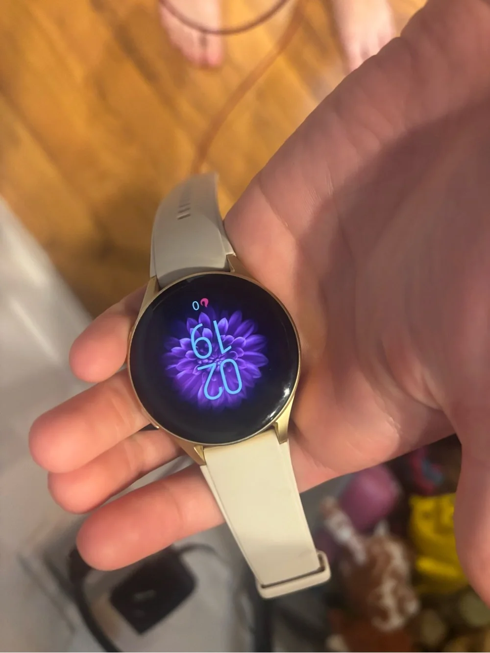 Gold-Trim Smartwatch with White Band and Floral Display